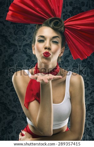 Vintage woman in red dress with big red bow in head