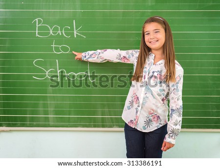 Student shows a board with the inscription: Back to School