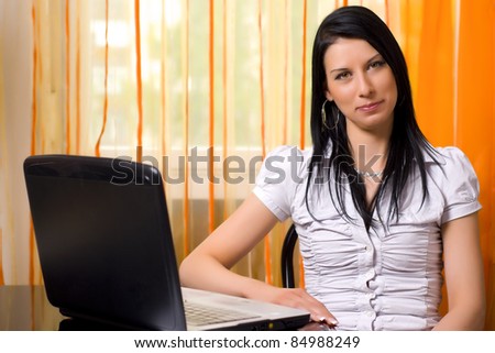 Secretary young woman smiling sitting in front of laptop