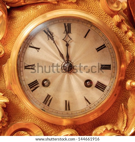 Vintage antique golden clock face, closeup.