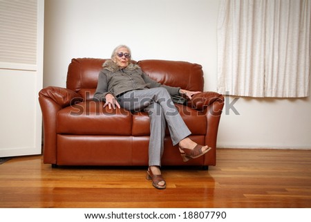 Senior Woman Sitting On Leather Sofa At Home Stock Photo 18807790 ...