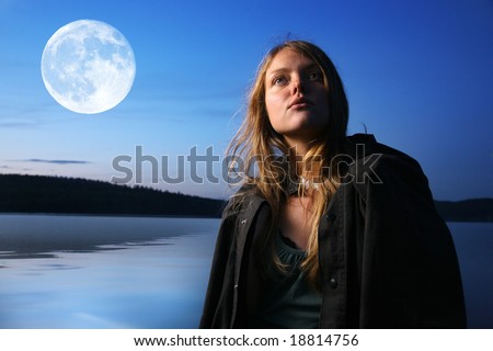 Beautiful young woman at night outdoors at lake