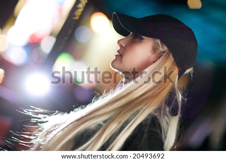Beautiful blond woman in night city. Shallow DOF.