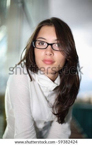 Portrait of beautiful young female model posing outside on blurred background. Shallow DOF.