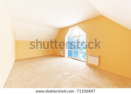 Spacious attic room interior, sky view in window.