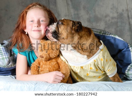 girl with her pet sleeping in bed