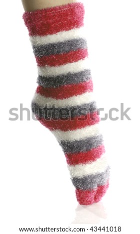 pointed toe with fuzzy red toe socks on with reflection on white background