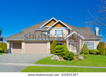 A custom built luxury triple doors garage house in a residential neighborhood. North America.