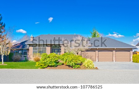 Custom built  big luxury house with three doors garage in a residential neighborhood. Suburbs of Vancouver ( Surrey ) Canada.
