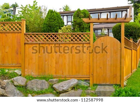 Wooden gate ( wicket )  and fence to the front ( back ) yard.