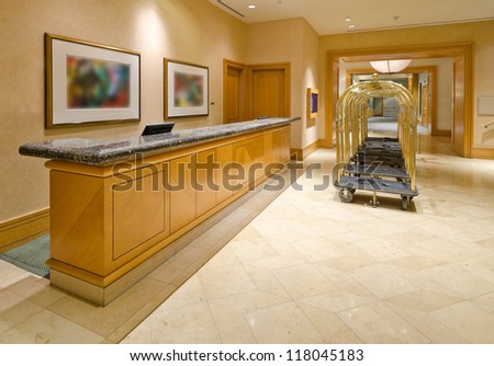 Fragment of the lobby of the luxury five stars hotel with the luggage carts and the counter.