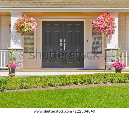 Entrance of a house with some flowers aside.