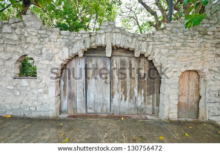 Old looking closed wooden rustic gates (doors). Mexico. Something behind.