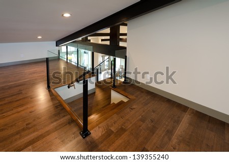 Entrance to the luxury spacious modern nicely and simply decorated upper home level with finished hardwood floor.  Interior design.