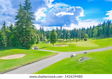 Beautiful golf course  in a sunny day with dark blue sky and clouds. Canada, Vancouver.