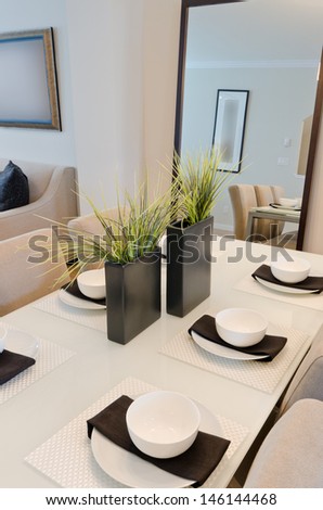 Nicely decorated and served living, lunch room table with the coffee, tea set. Interior design. Vertical.