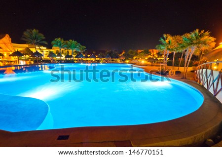 Swimming pool at a luxury caribbean resort at night, dawn time. Bahia Principe, Riviera Maya, Mexican Resort.
