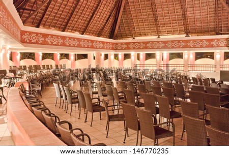 Theater interior.  Rows of chairs facing theatrical scene, stage.  Old theater of the luxury caribbean resort. Bahia Principe, Riviera Maya, Mexican Resort.