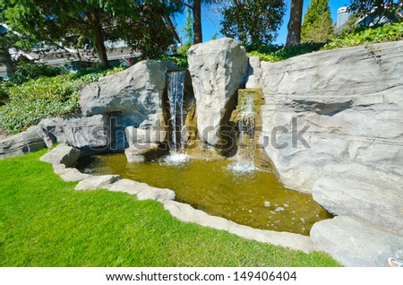 Artificial waterfall as an element of urban community landscape design.
