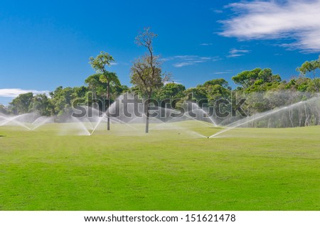Golf course gets irrigated. Golf field, course sprinkling. Mexican resort. Bahia Principe, Riviera Maya.