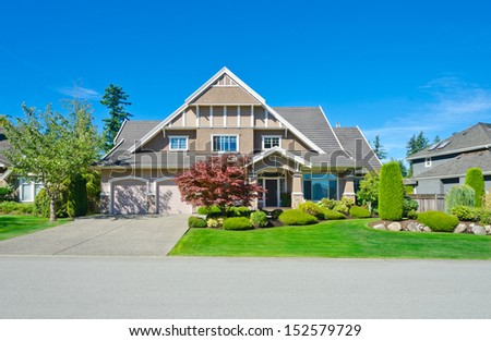 Big custom made luxury house with nicely landscaped front yard in the suburbs of Vancouver, Canada.