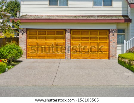 Double doors garage and long driveway. North America.