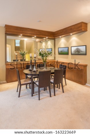 Luxury and nicely decorated dining, lunch room set, with the table and the vase with some flowers . Interior design.