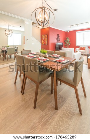 Luxury living suite : nicely decorated dining table and the living room at the back. Interior design.