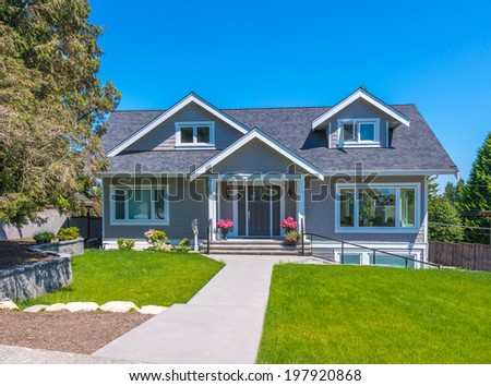 Big custom made luxury house with nicely trimmed and landscaped front yard  in the suburb of Vancouver, Canada.