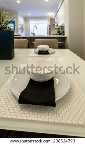 Nicely decorated dining table with cup, plate and napkin. Interior design. Vertical.