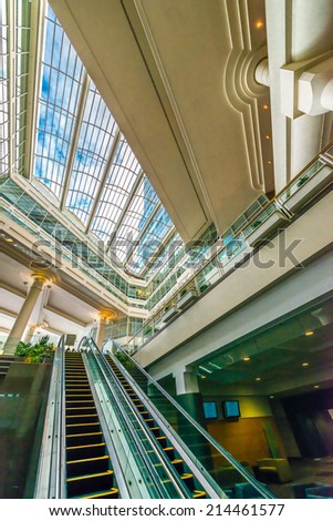 Abstract fragment of the architecture of modern lobby, hallway of the luxury hotel, shopping mall, business center with empty escalator stairs in Vancouver, Canada. Interior design.
