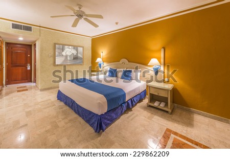 Modern comfortable and elegant master bedroom in a luxury mexican, caribbean  resort hotel. Interior design.