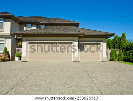 Triple doors garage and wide driveway. North America. Vancouver.