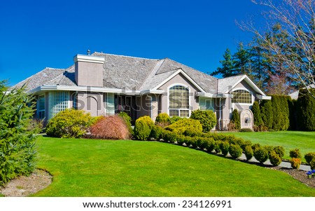 Big custom made luxury house with nicely landscaped front yard in the suburbs of Vancouver, Canada.