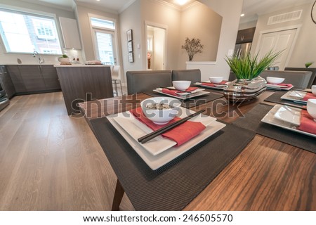 Nicely decorated in oriental style dining table and kitchen room at the back. Interior design.