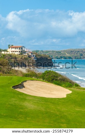Gorgeous view at the golf course with sand bunkers at the ocean side. Luxury Mexican resort. Gorgeous view at the golf course with sand bunkers at the ocean side. Vertical.
