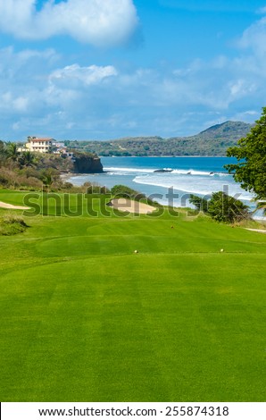 Gorgeous view at the golf course with sand bunkers at the ocean side. Luxury Mexican resort. Gorgeous view at the golf course with sand bunkers at the ocean side. Vertical.