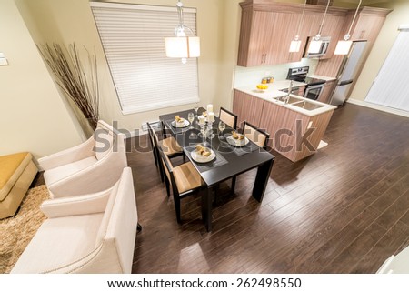 View from above: luxury living suite, nicely decorated dining table and the kitchen at the back. Interior design.