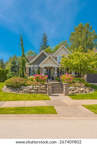 Big custom made luxury house with nicely landscaped front yard in the suburb of Vancouver, Canada.