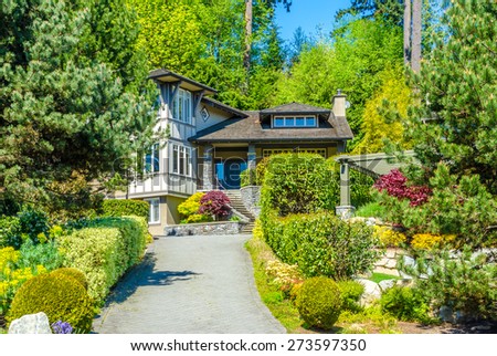 Big custom made luxury house with nicely landscaped front yard  in the suburbs of Vancouver, Canada.