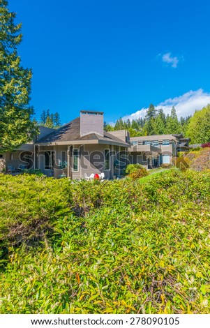 Big custom made luxury house with nicely landscaped front yard  in the suburbs of Vancouver, Canada. Vertical.