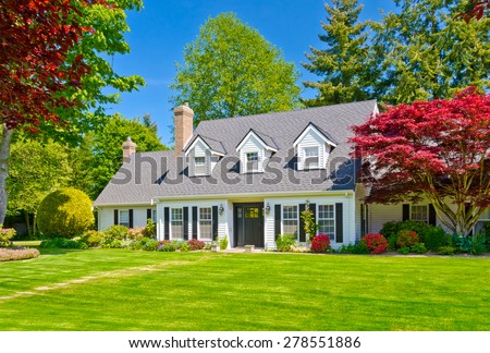 Custom built luxury house with nicely trimmed and decorated front yard, lawn in a residential neighborhood. Vancouver Canada.