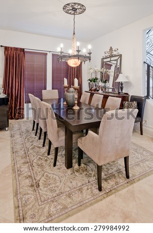 Nicely decorated dining, lunch room. Dining table and a few chairs around. Vertical. Interior design.