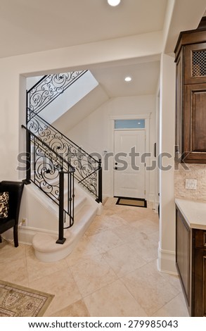 Stairs and handrail leading to the upper, low level. Interior design of a luxury modern house.