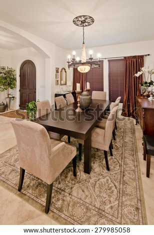 Nicely decorated dining, lunch room. Dining table and a few chairs around. Vertical. Interior design. Vertical.