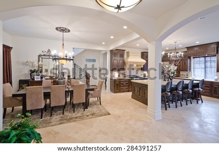 Luxury living site. Nicely decorated dining, lunch room and kitchen at the back. Dining table and a few chairs around. Interior design.