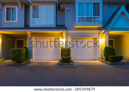 Townhouses, homes, community, garages at  dusk, night time in suburbs of Vancouver, Canada.