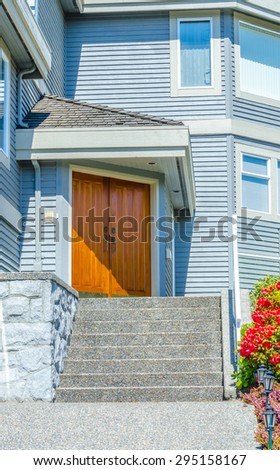 House entrance with the stairs to the door. Vertical.
