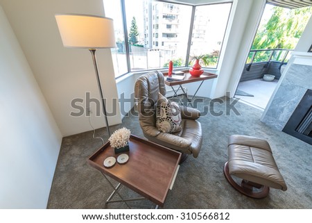 Interior design of luxury nicely decorated modern living room, suite with some leather chairs and coffee table. Interior design.