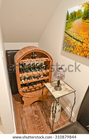 Wine bottles stacked on wooden racks. Interior design.